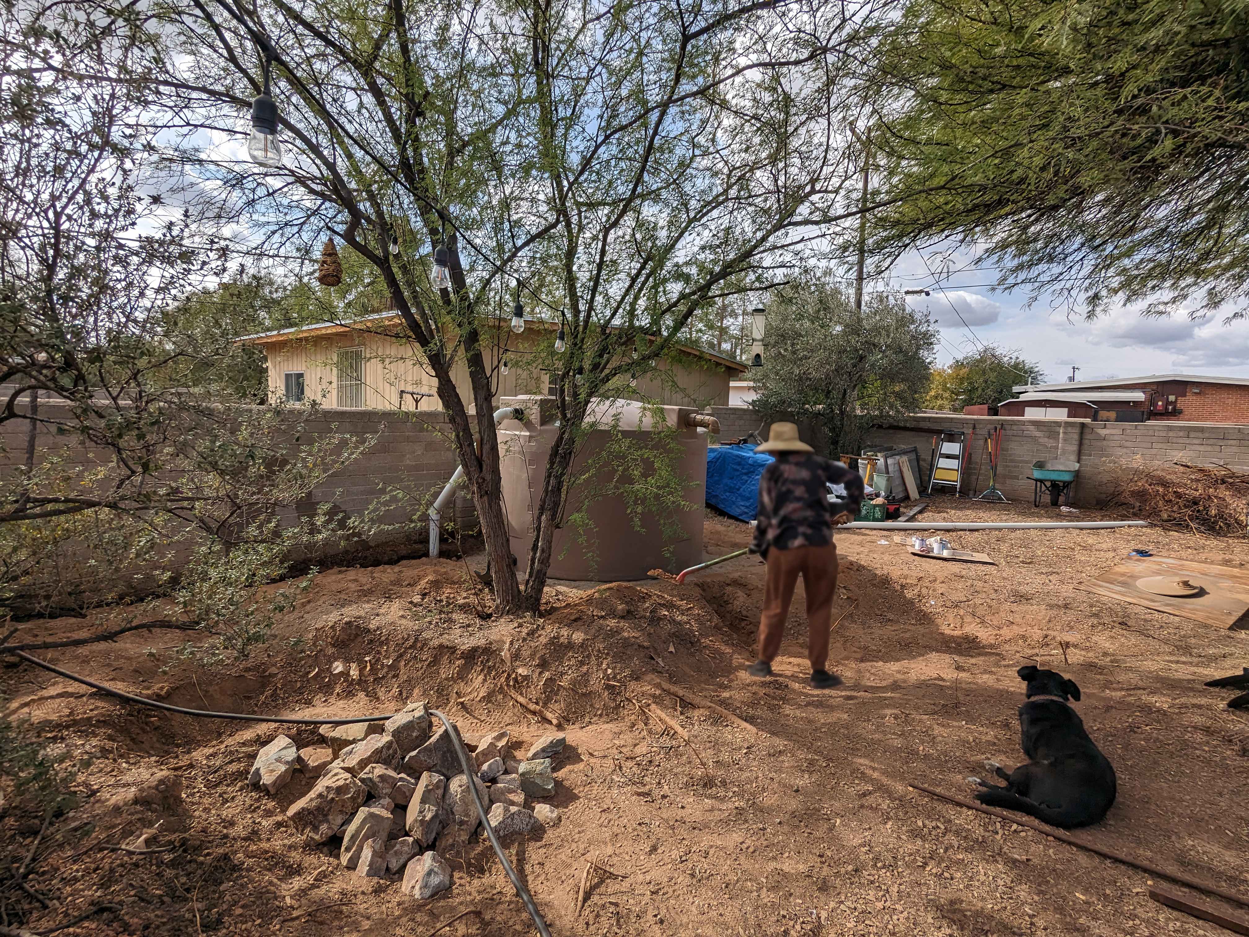 A Tucson resident works on their backyard landscaping after the installation of a cistern. These 1,500-gallon tanks store rainwater collected from residential roofs to be used for outdoor irrigation.